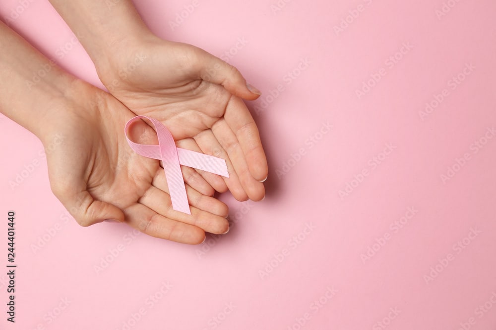 Free Stock Images to use for Website Hero Images: Person Holding Pink Heart Ribbon